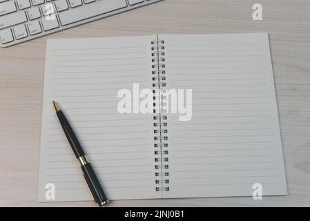 keyboard computer and book with pen on desk. Stock Photo