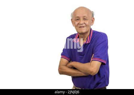 Asian elderly man standing with his arms crossed white background. Stock Photo