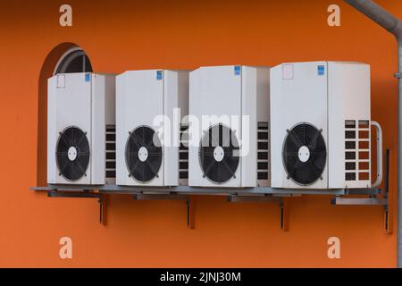 Air source heat pumps installed on the outside of a modern house Stock Photo