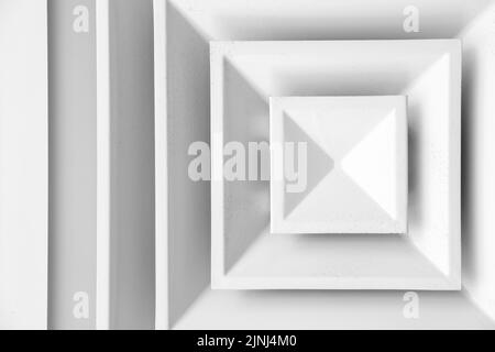White ceiling ventilation grille with dust on square diffusors, close up photo Stock Photo