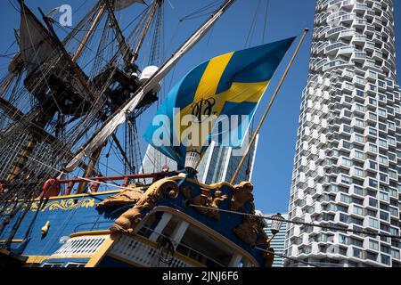 The replica sailing ship, Gotheborg, is docked beneath the high-rise towers at South Quay, Canary Wharf in London Docklands, during its four-day visit to the capital before it continues its two-year around the world expedition to Shanghai, China, on 9th August 2022, in London, England. Londoners are invited to tour the decks of this facsimile of the original ship which sank off the Swedish coast in 1745. Its main cargo would have been tea, porcelain, herbs and silk on the China route. Stock Photo