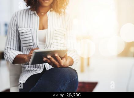 Business woman typing on a tablet, replying to emails and checking notifications while sitting in office at work. Manager, professional worker and Stock Photo