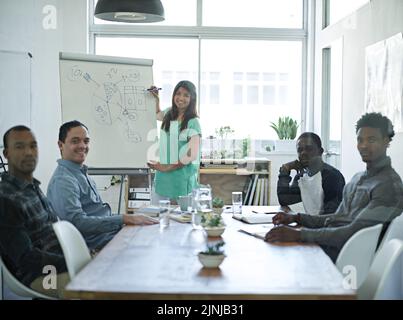 Manager, female leader or colleague presenting, training or teaching diverse team of creative marketing agents in office boardroom. Portrait of Stock Photo