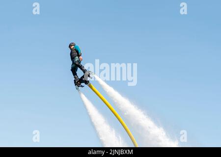 Flyboard. Air Farthest flight by hoverboard. Man flying on Board