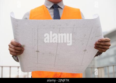 Building plan in hands of construction engineer Stock Photo