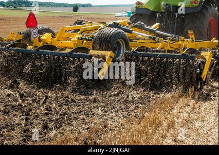 multi-disc cultivator, tillage system in operation with tractor Stock Photo