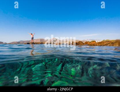 Datca town view and sea. Amateur fisherman on cliffs. Datca, Mugla, Turkey - August 2022 Stock Photo