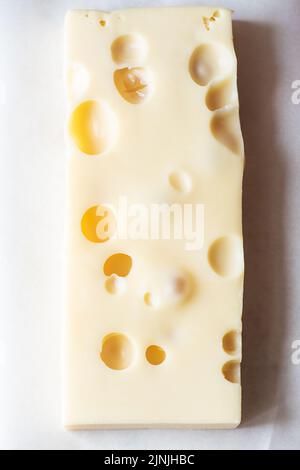 French emmental semi-hard cheese, close up, selective focus. Stock Photo