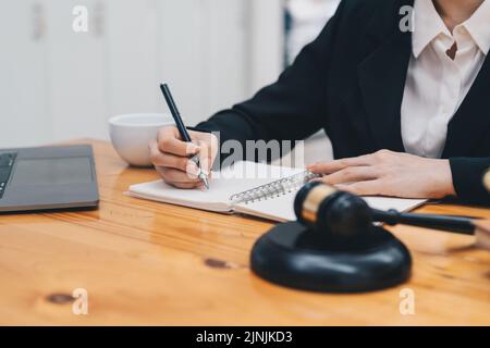 Judge gavel with Justice lawyers, Business woam in suit or lawyer working on a documents. Legal law, advice and justice concept Stock Photo