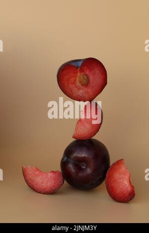 plums on the yellow background with copy space Stock Photo