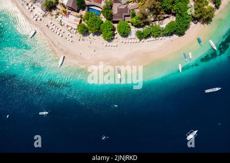 Gili Air with tropical beach and transparent ocean with boats, aerial view. Tropical islands Stock Photo