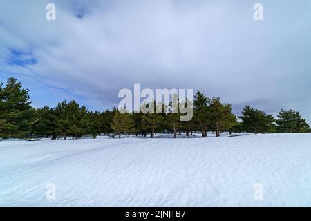Snowscape on the mountain of Madrid with sun, blue sky and high mountain. Stock Photo
