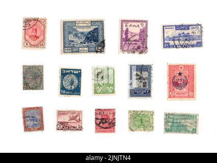 A selection of old postage stamps from the Middle East on a white background. Stock Photo