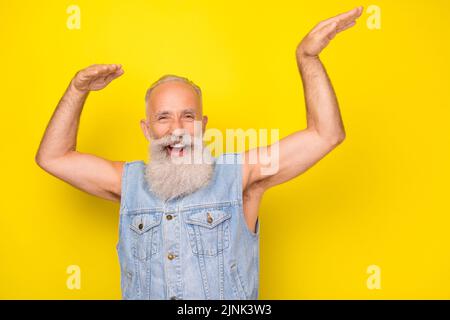 Photo of handsome charming man pensioner dressed denim dancing having fun isolated yellow color background Stock Photo