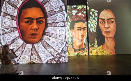 London UK 12 August 2021  Frida Kahlo and Diego Rivera, two of Mexico’s greatest ever painters. Their work captures beauty, love, and deep emotions, and you can see their paintings come to life at dazzling art. Dock X in Canada Water until end of October 2022.,Paul Quezada-Neiman/Alamy Live News Stock Photo