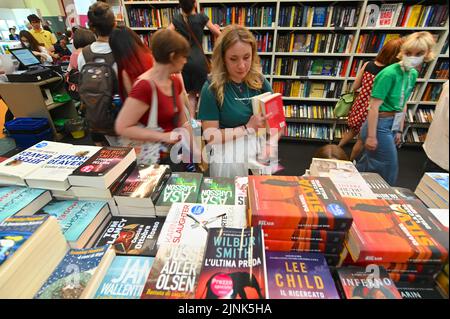 People of different ages and gender choosing books at a bookstore Stock Photo