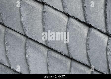 Detail close-up of natural grey stone shingle slate tiles texture roof abstract surface background. Natural mineral material dark rock plate building Stock Photo