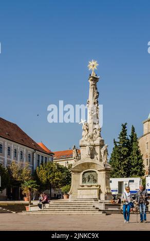 Pecs, Hungary - October 06, 2018: Obeliskl - Monument St. Trinity in Pecs in front of Mosque Qazim in the Main Square in Pecs Hungary. Stock Photo