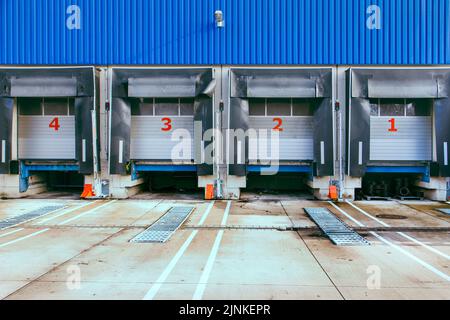 A closeup of loading ramps with numbers on closed shutter doors Stock Photo