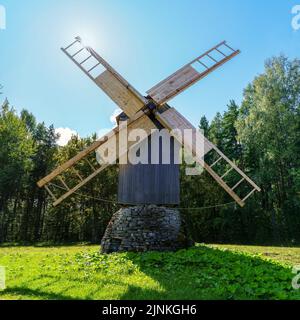 Very old wooden windmill and sunbeams between the blades. Stock Photo