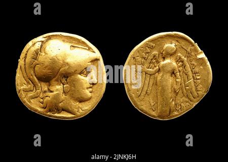 Two sides of an ancient greek gold coin with Alexander the Great isolated on black background. Stock Photo