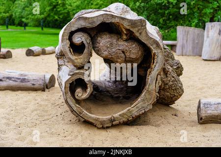 Hollow log in a playground for children to play with. Stock Photo