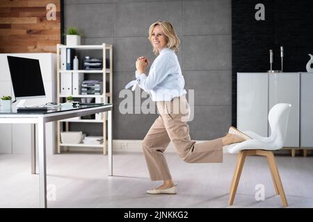 Squat Employee Doing Bulgarian Split Squat Exercise In Office Stock Photo