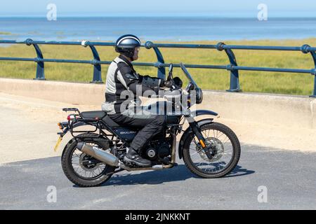 Royal Enfield Himalayan 20 Single AC 4T EU4 Black Motorcycle Body Style Fuel Petrol Engine Size 411cc, motorcycle rider; on the coast road in Southport, UK Stock Photo