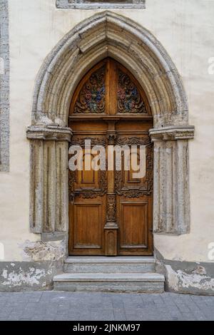 Very old door in stone arch with medieval style. Stock Photo