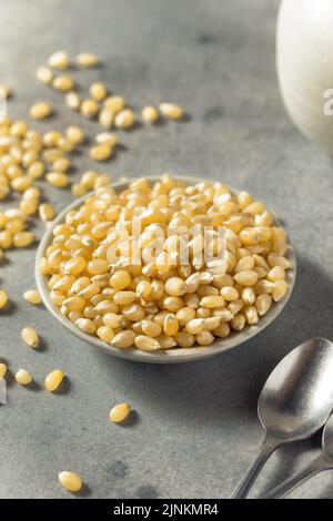 Dry Organic White Popcorn Kernels in a Bowl Stock Photo
