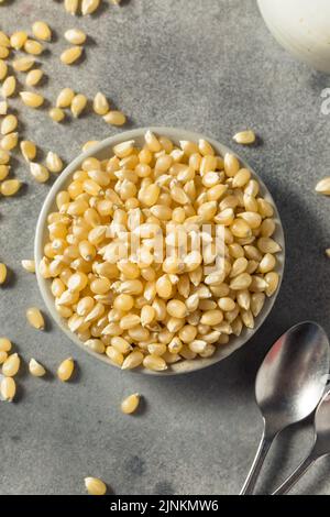 Dry Organic White Popcorn Kernels in a Bowl Stock Photo