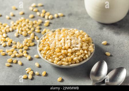 Dry Organic White Popcorn Kernels in a Bowl Stock Photo