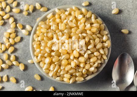 Dry Organic White Popcorn Kernels in a Bowl Stock Photo