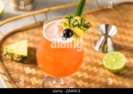 Boozy Cold Rum Runner Cocktail with Cherry and PIneapple Stock Photo