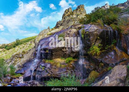 Cascade of fresh water falling between the rocks of the high mountains. Somosierra Madrid. Stock Photo