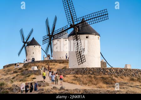 Consuegra, SPAIN - June 25 2022: Windmills from Consuegra Village, visited by hundreds of people every day. The story of Don Quixote starts from this Stock Photo