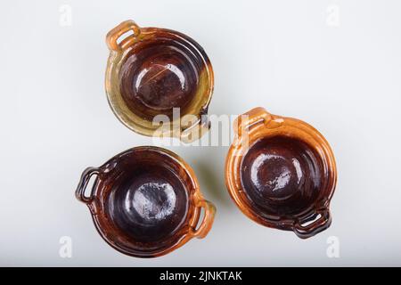 Top view of ceramic clay pots(cassoles) isolated on white background. Flat lay Stock Photo