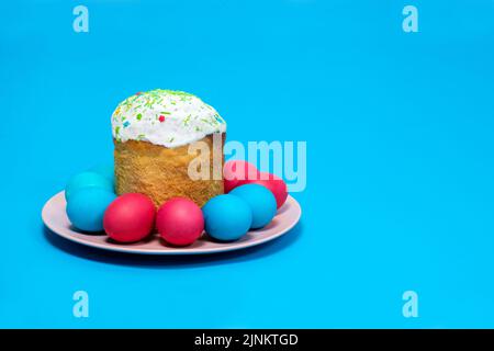 Easter cake and painted eggs on a blue background, copy the place for the text Stock Photo
