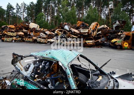 IRPIN, UKRAINE - AUGUST 11, 2022 - Sunflowers painted by artists are seen on the cars shot by the Russians during Russia's full-scale invasion of Ukra Stock Photo