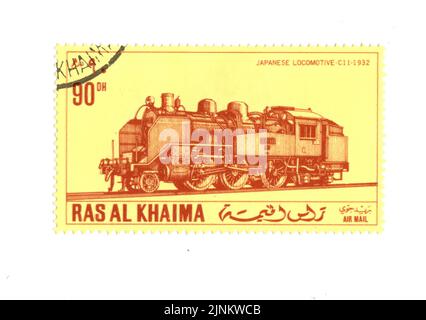 An old postage stamp featuring a steam train on a white background. Stock Photo