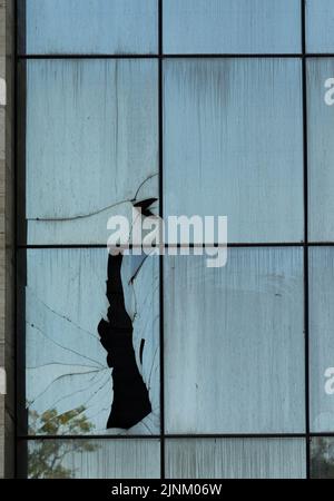 Broken windows in a modern building on the urban area Stock Photo