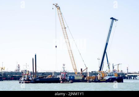 Wilhelmshaven, Germany. 12th Aug, 2022. Several pontoons and floating cranes lie at the construction site for the planned LNG terminal in the North Sea off Wilhelmshaven. Minister President Weil visited the future jetty together with Lower Saxony's Environment Minister Lies. Credit: Hauke-Christian Dittrich/dpa/Alamy Live News Stock Photo
