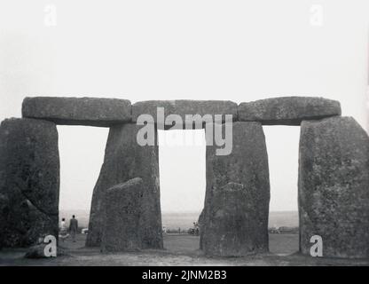 1950s, historical, view from this era of a section of four of the prehistoirc standing stones at Stonehenge on Salisbury Plain in Wiltshire, England, UK.  The whole monument consists of an outer ring of vertical sarsen standing stones, approx 13 feet high and seven feet wide, and weighing around 25 tons, topped by connecting horizontal lintel stones. Stock Photo