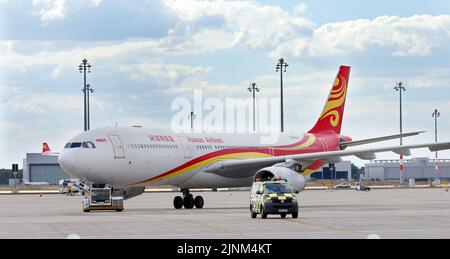 Brandenburg, Germany. 12th Aug, 2022. 12 August 2022, Brandenburg, Schönefeld: An Airbus A330-300 aircraft of the Chinese airline Hainan Airlines is towed across the tarmac before its first flight at Berlin Brandenburg Airport. Photo: Wolfgang Kumm/dpa Credit: dpa picture alliance/Alamy Live News Stock Photo