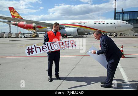 Brandenburg, Germany. 12th Aug, 2022. 12 August 2022, Brandenburg, Schönefeld: Thomas Hoff Andersson (l), COO Berlin Brandenburg Airport, and Stefan Pampel, Account Manager of Hainan Airlines, stand in front of one of the airline's Airbus A330-300 aircraft before the Chinese carrier's maiden flight at Berlin Brandenburg Airport. Photo: Wolfgang Kumm/dpa Credit: dpa picture alliance/Alamy Live News Stock Photo