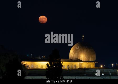 Full moon shines over Al-Aqsa Mosque located on the Temple Mount known to Muslims as the Haram esh-Sharif in the Old City East Jerusalem Israel Stock Photo