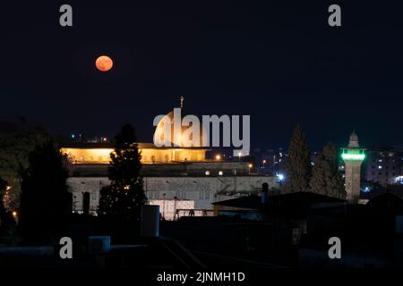 Full moon shines over al-Fakhariyya Minaret and Al-Aqsa Mosque located on the Temple Mount known to Muslims as the Haram esh-Sharif in the Old City East Jerusalem Israel Stock Photo