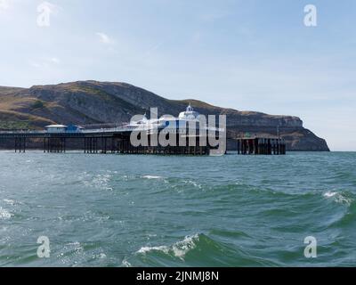 Llandudno, Clwyd, Wales, August 07 2022: The Great Orme and Pier as seen from the sea. Stock Photo