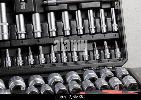 A professional set of ratchets and sockets with chrome tool steel tips on a gray background Stock Photo
