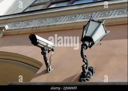Old vintage lantern and camera on building wall in Kyiv Ukraine Stock Photo